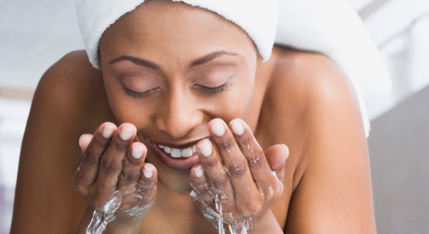 African American woman washing face